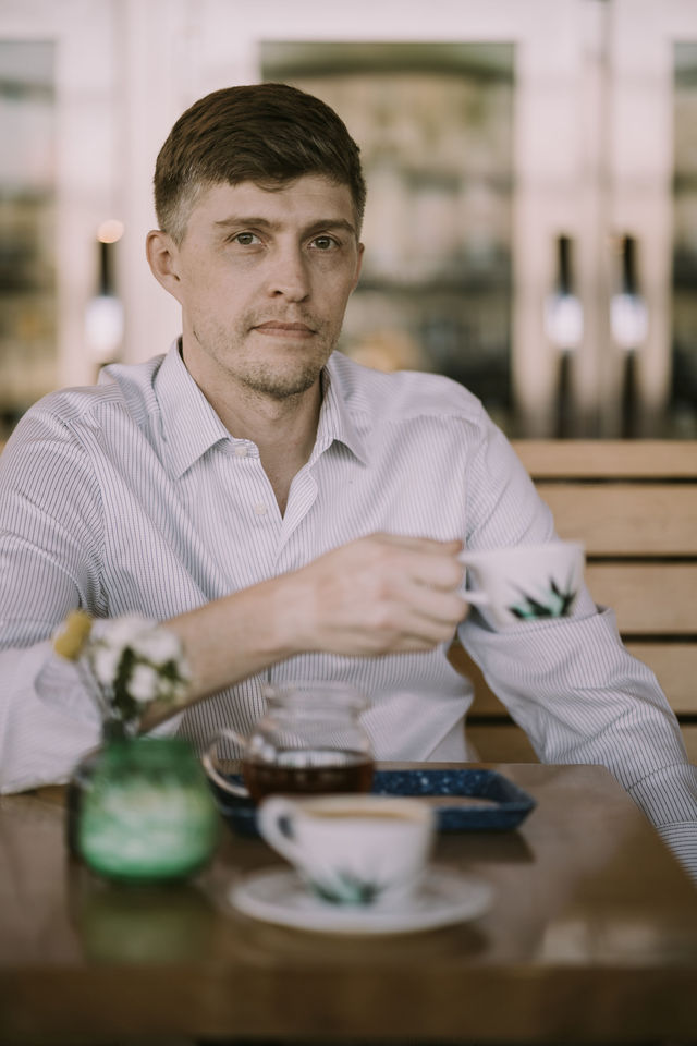 Dating profile photo with coffee, taken by The Match Artist